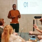 Man in Sweatshirt In Front of People