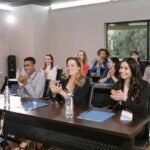 Group of People in a Conference Room Clapping